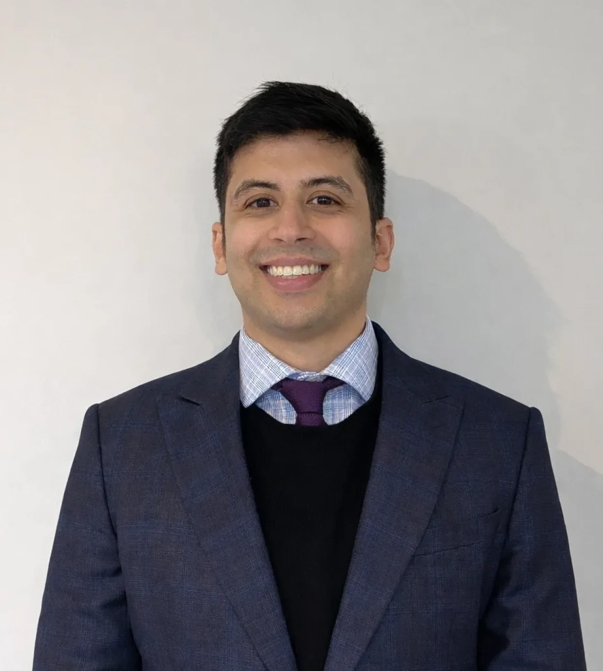 Man in business attire smiling